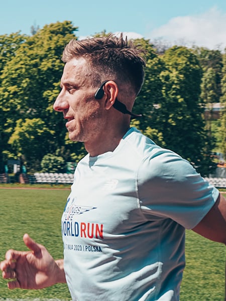 Mężczyzna biegnący w maratonie ze słuchawkami sportowymi firmy Philips